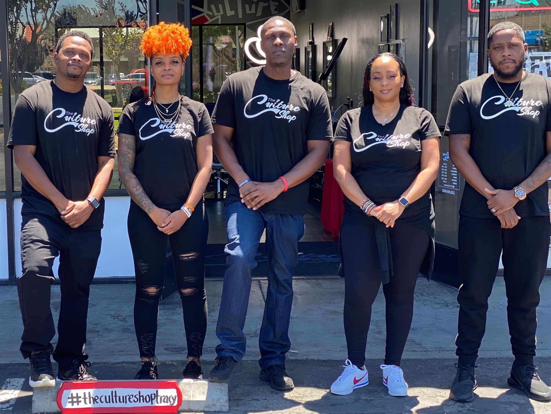 The Culture Shop team standing outside the shop